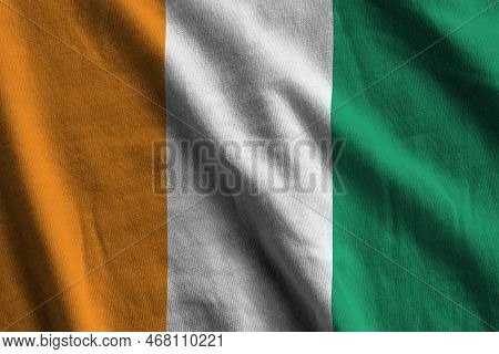 Ivory Coast Flag With Big Folds Waving Close Up Under The Studio Light Indoors. The Official Symbols