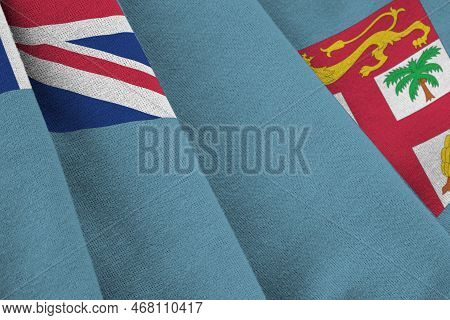 Fiji Flag With Big Folds Waving Close Up Under The Studio Light Indoors. The Official Symbols And Co