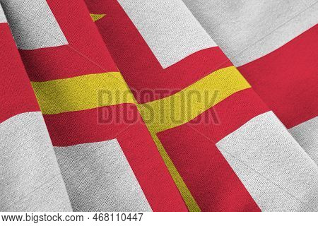Guernsey Flag With Big Folds Waving Close Up Under The Studio Light Indoors. The Official Symbols An