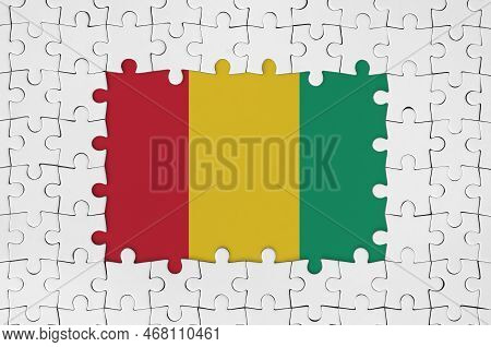 Guinea Flag In Frame Of White Puzzle Pieces With Missing Central Parts