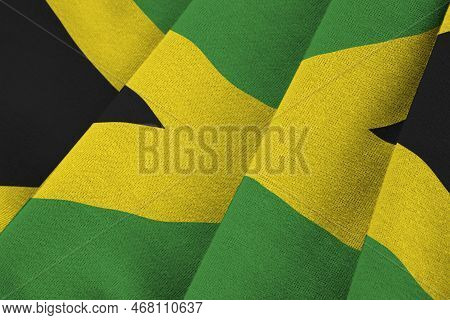Jamaica Flag With Big Folds Waving Close Up Under The Studio Light Indoors. The Official Symbols And