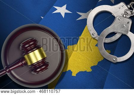 Kosovo Flag With Judge Mallet And Handcuffs In Dark Room. Concept Of Criminal And Punishment, Backgr