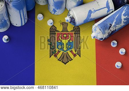 Moldova Flag And Few Used Aerosol Spray Cans For Graffiti Painting. Street Art Culture Concept, Vand