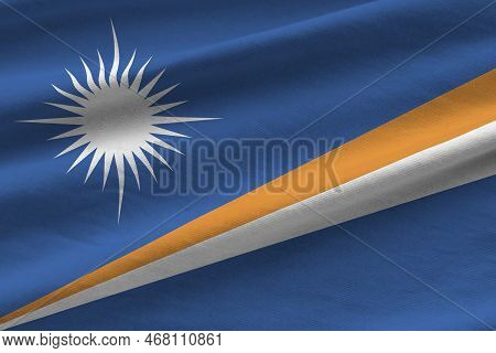 Marshall Islands Flag With Big Folds Waving Close Up Under The Studio Light Indoors. The Official Sy