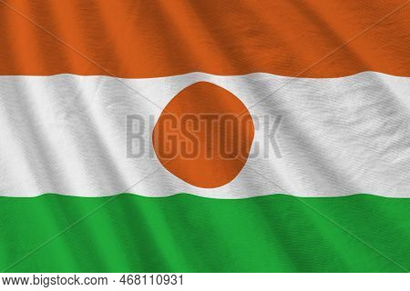 Niger Flag With Big Folds Waving Close Up Under The Studio Light Indoors. The Official Symbols And C