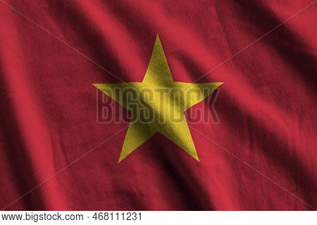 Vietnam Flag With Big Folds Waving Close Up Under The Studio Light Indoors. The Official Symbols And