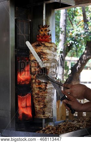 A Chicken Shawarma Skewer Roasting On A Rotating Pole.