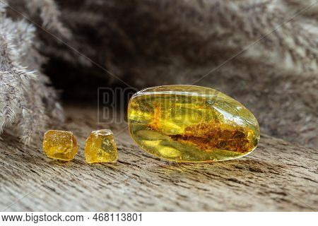 Amber-like Yellow Copal With Rosin Mineralized Stones Samples On Wooden Background