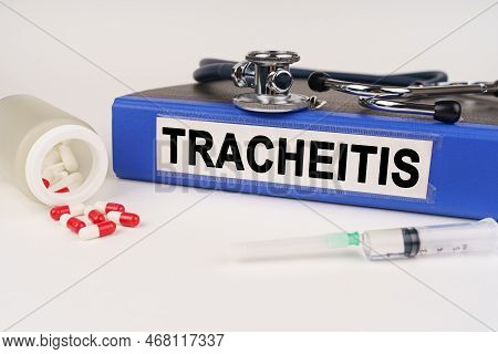 Medical Concept. On A White Surface There Are Pills, A Syringe, A Stethoscope And A Folder With The 