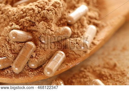Guarana Capsules In Guarana Powder In A Wooden Spoon .healthy Eating.transparent Capsules With Guara