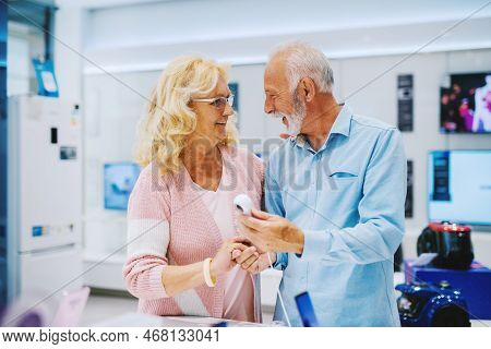 Seniors Shopping Appliences And Gadgets In Tech Store.