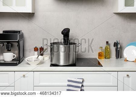 Pot With Sous Vide Cooker In Kitchen. Thermal Immersion Circulator