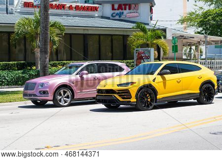 Miami Beach, Florida Usa - April 15, 2021: Bentley Bentayga V8 2015 And Giallo Auge Lamborghini Urus