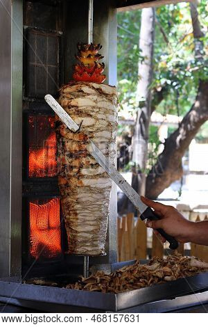 A Chicken Shawarma Skewer Roasting On A Rotating Pole.