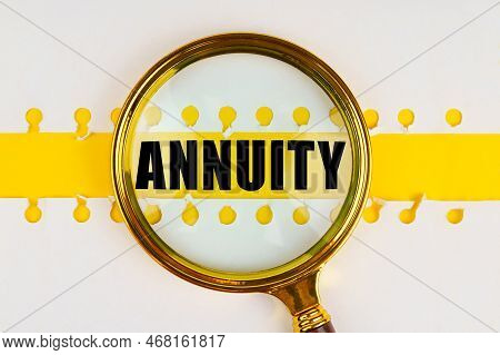 Between Two Sheets From A Notebook On A Yellow Strip With The Inscription - Annuity, There Is A Magn