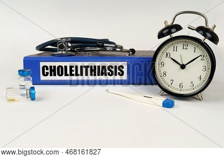 Medical Concept. On A White Surface, A Thermometer, Ampoules, A Stethoscope, An Alarm Clock And A Fo