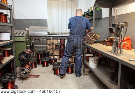 Production Of Copper Wire, A Man Works In A Workshop At An Electric Engine Plant