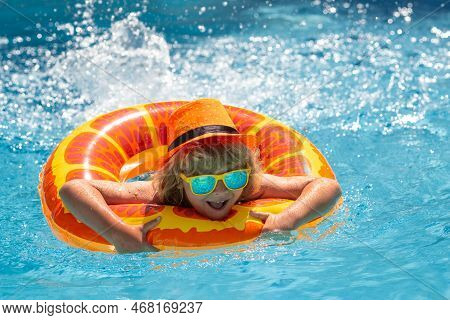 Kid Boy Relaxing In Pool. Child Swimming In Water Pool. Summer Kids Activity, Watersports. Summer Va