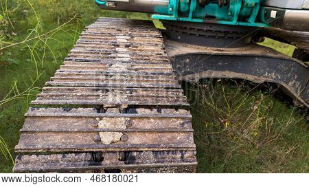 Excavator Tracks. Old Iron Caterpillars Of The Bulldozer Of The Tractor On The Road. Bulldozer Cater