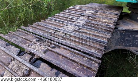 Excavator Tracks. Old Iron Caterpillars Of The Bulldozer Of The Tractor On The Road. Bulldozer Cater