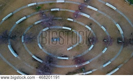 Massive Concrete Blocks Of Bench In The Park Are Connected By Granite Blocks In The Shape Of A Spira