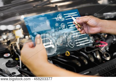 Technician Holding Old Spark Plug And Analyze The Symptoms Of Engine Damage With Modern Technology O