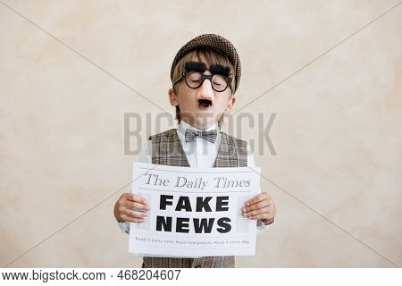 Newsboy Shouting Against Grunge Wall Background. Boy Selling Fake News