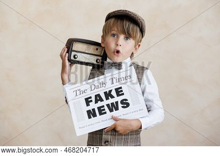 Newsboy Shouting Against Grunge Wall Background. Boy Selling Fake News