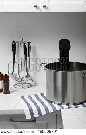 Pot With Sous Vide Cooker In Kitchen. Thermal Immersion Circulator