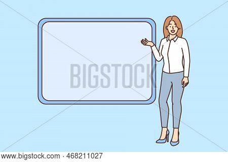 Smiling Woman Presenter Or Coach Point At Mockup Board Make Presentation. Happy Businesswoman Presen