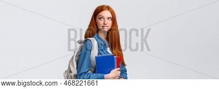 Creative And Thoughtful Cute Daring Foxy Girl With Red Hair, Hold Backpack And Notebooks, Biting Lip