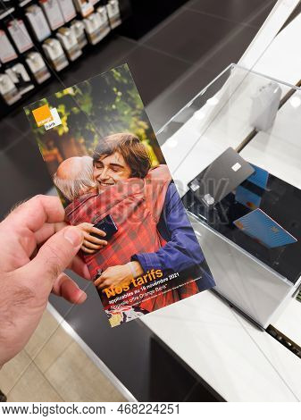 Lyon France - Nov 19, 2021: Pov Male Hand Reading Instrcutions On The Booklet For The Mastercard Ora