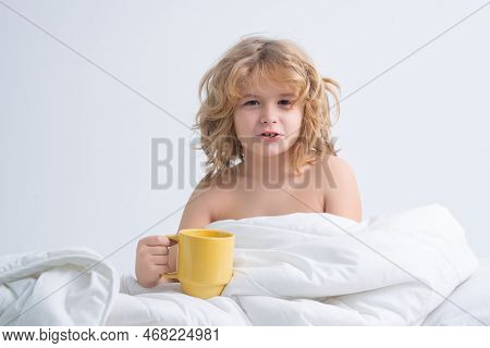 Morning Drink. Kid With Cup In Bed. Cute Awaking Child In Bed, Bedtime, Childhood And Growth Kids Co