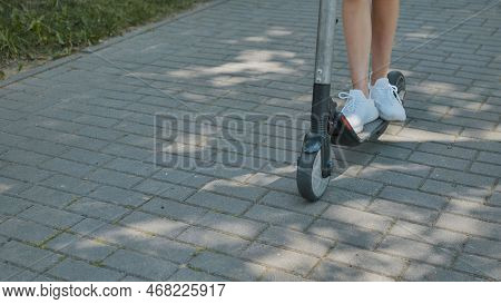A Girl Rolls Around On City Tiles In The Park.