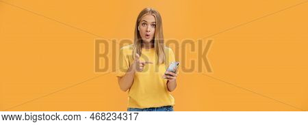 Wman Impressed By Wireless Earphones Connecting To Smartphone Themselves Pointing At Device Screen Q