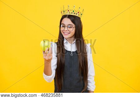 Princess Child In Queen Crown Hold Apple Isolated On Yellow Background. Teenage Girl Wear Diadem. Ha