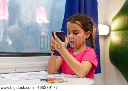 Child Traveling By Train. Little Kid In A High Speed Express Train On Family Vacation Europe. Travel