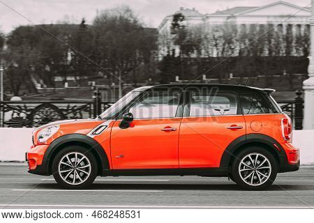 Minsk, Belarus - April 7, 2017: Orange Color Mini Cooper All 4 Car In Fast Motion On Street. All Col