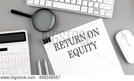 Return On Equity Written On A Paper With Office Tools And Keyboard On The Grey Background