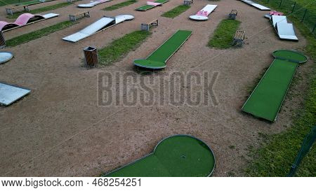 Minigolf Course In Park Catch Golf Balls Behind Obstacle. Game For Points Below Par Or Above Par, Re
