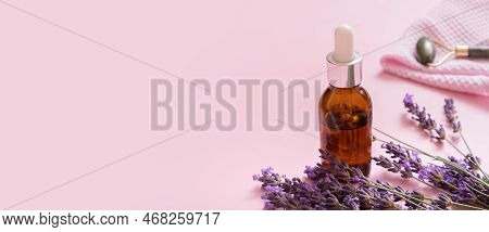 Banner With Dropper Bottle And Face Skin Massager With Lavender Flowers On Colored Background
