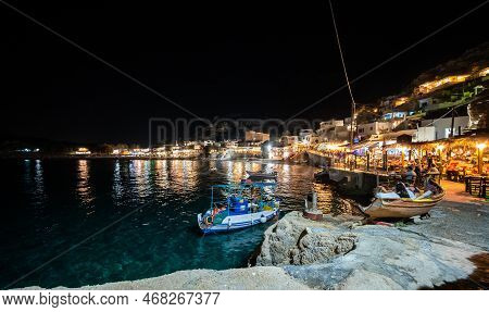 Night View Of Matala Village Restaurants In Crete, Greece. Nightscape Of Lights And Taverns In The G