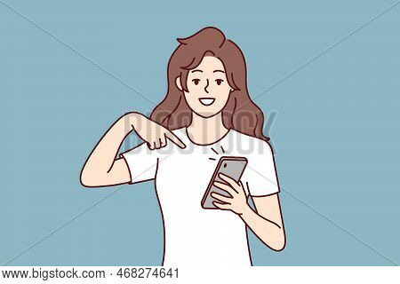 Happy Woman Points Finger At Mobile Phone Screen To Announce That Read Great News. Positive Girl Wit