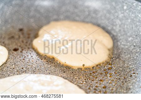 Frying Kefir Based Pancakes In Cooking Pan On An Electric Stove.
