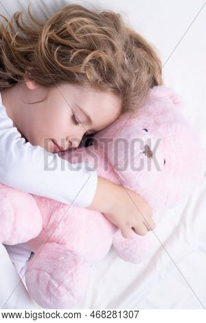Morning Sleep. Adorable Kid Sleeps With A Toy Teddy Bear In Bed. Sleeping Child.