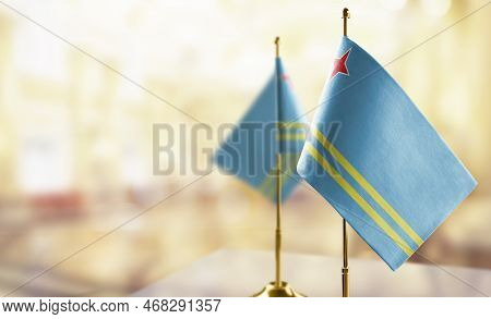 Small Flags Of The Aruba On An Abstract Blurry Background