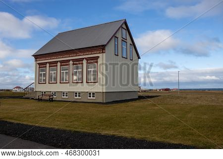 Tradidtional Design Of A Small School With Big Windows, Surrounded By Green Grass, Beside The North 