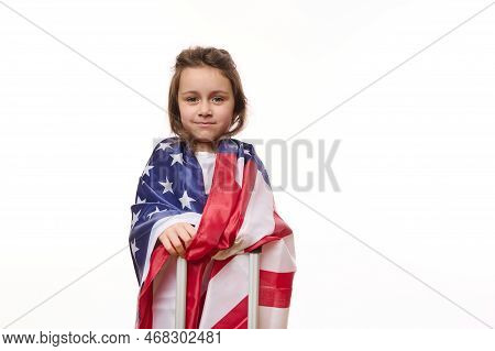 Isolated Portrait On White Background Of A Happy American Little Girl With Usa Flag And Suitcase. Ci