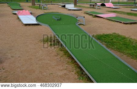 Minigolf Course In Park Catch Golf Balls Behind Obstacle. Game For Points Below Par Or Above Par, Re