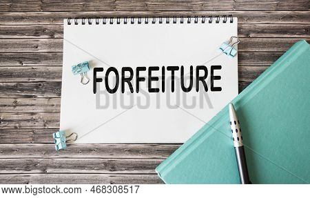 Forfeiture - Words On Notepad On Wooden Background .business Concept